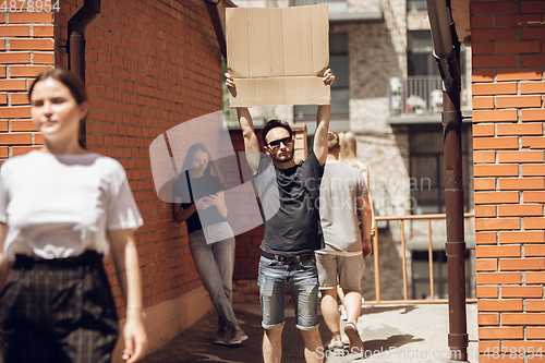 Image of Dude with sign - man stands protesting things that annoy him