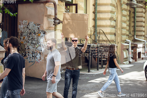 Image of Dude with sign - man stands protesting things that annoy him