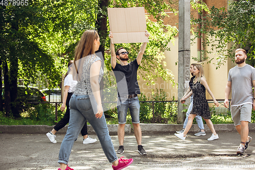 Image of Dude with sign - man stands protesting things that annoy him