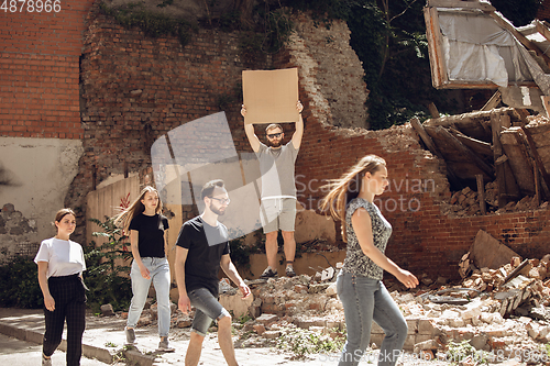 Image of Dude with sign - man stands protesting things that annoy him