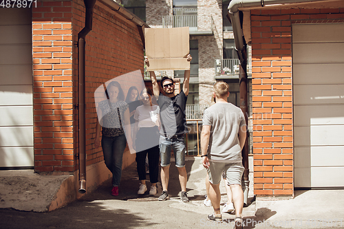 Image of Dude with sign - man stands protesting things that annoy him