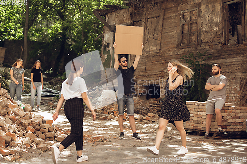 Image of Dude with sign - man stands protesting things that annoy him