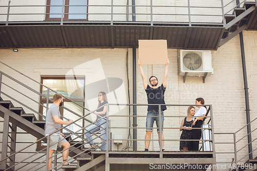 Image of Dude with sign - man stands protesting things that annoy him