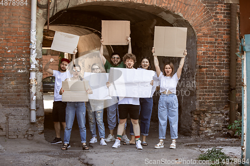 Image of Diverse group of people protesting with blank signs. Protest against human rights, abuse of freedom, social issues