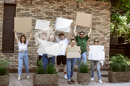 Image of Diverse group of people protesting with blank signs. Protest against human rights, abuse of freedom, social issues