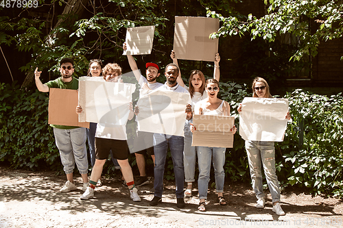 Image of Diverse group of people protesting with blank signs. Protest against human rights, abuse of freedom, social issues