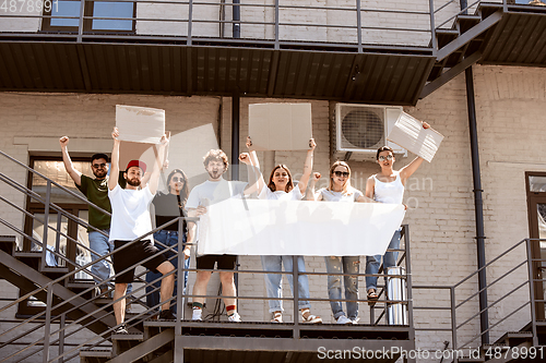 Image of Diverse group of people protesting with blank signs. Protest against human rights, abuse of freedom, social issues