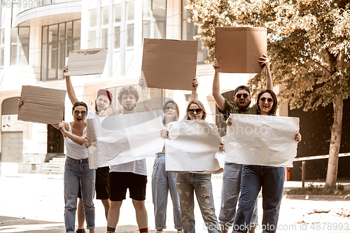 Image of Diverse group of people protesting with blank signs. Protest against human rights, abuse of freedom, social issues