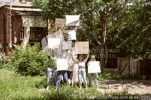 Image of Diverse group of people protesting with blank signs. Protest against human rights, abuse of freedom, social issues