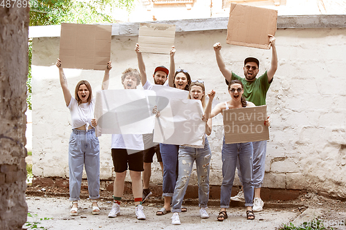 Image of Diverse group of people protesting with blank signs. Protest against human rights, abuse of freedom, social issues