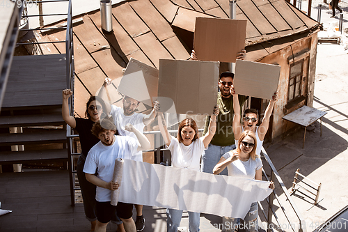 Image of Diverse group of people protesting with blank signs. Protest against human rights, abuse of freedom, social issues