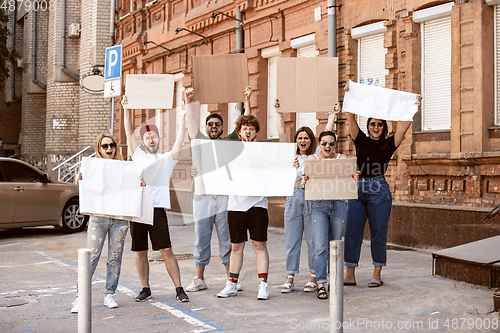 Image of Diverse group of people protesting with blank signs. Protest against human rights, abuse of freedom, social issues