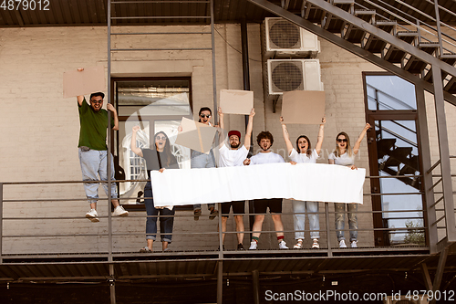 Image of Diverse group of people protesting with blank signs. Protest against human rights, abuse of freedom, social issues