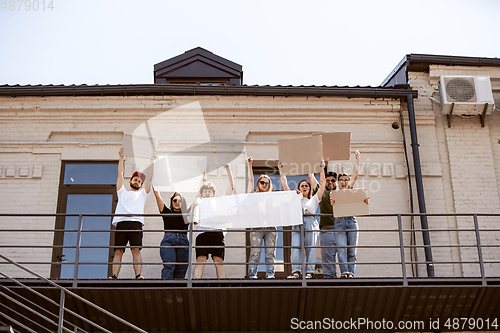 Image of Diverse group of people protesting with blank signs. Protest against human rights, abuse of freedom, social issues