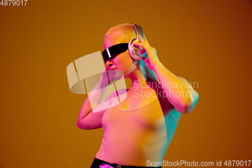 Image of Portrait of young caucasian woman in fashionable eyewear on brown background with copyspace, unusual and freaky appearance