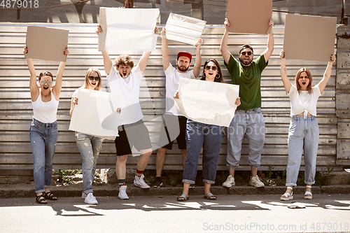 Image of Diverse group of people protesting with blank signs. Protest against human rights, abuse of freedom, social issues