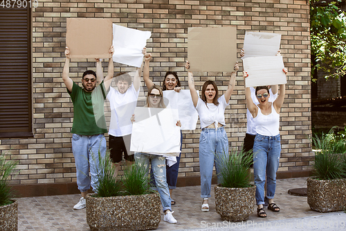 Image of Diverse group of people protesting with blank signs. Protest against human rights, abuse of freedom, social issues