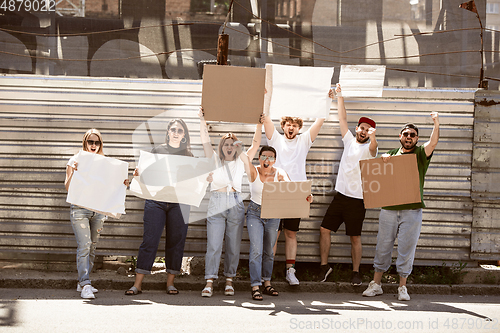 Image of Diverse group of people protesting with blank signs. Protest against human rights, abuse of freedom, social issues