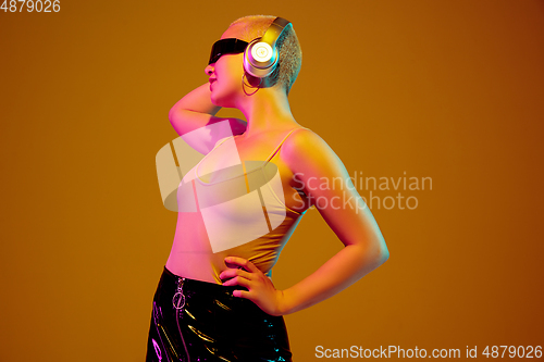 Image of Portrait of young caucasian woman in fashionable eyewear on brown background with copyspace, unusual and freaky appearance