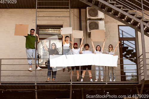 Image of Diverse group of people protesting with blank signs. Protest against human rights, abuse of freedom, social issues