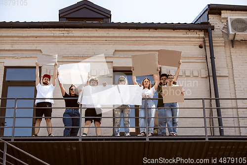 Image of Diverse group of people protesting with blank signs. Protest against human rights, abuse of freedom, social issues