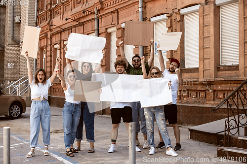 Image of Diverse group of people protesting with blank signs. Protest against human rights, abuse of freedom, social issues