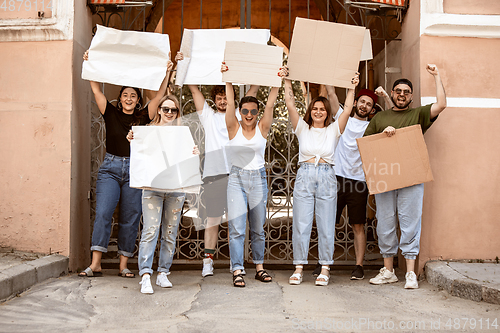 Image of Diverse group of people protesting with blank signs. Protest against human rights, abuse of freedom, social issues