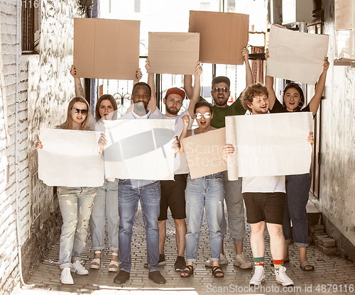 Image of Diverse group of people protesting with blank signs. Protest against human rights, abuse of freedom, social issues