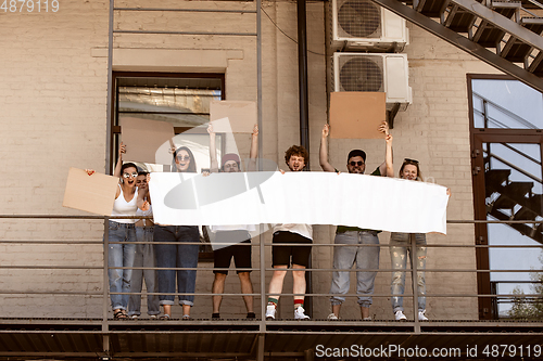 Image of Diverse group of people protesting with blank signs. Protest against human rights, abuse of freedom, social issues