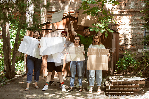 Image of Diverse group of people protesting with blank signs. Protest against human rights, abuse of freedom, social issues