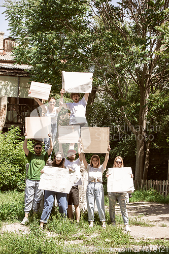 Image of Diverse group of people protesting with blank signs. Protest against human rights, abuse of freedom, social issues