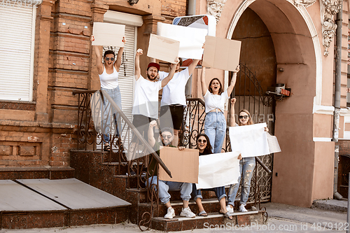 Image of Diverse group of people protesting with blank signs. Protest against human rights, abuse of freedom, social issues