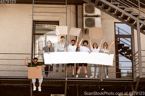 Image of Diverse group of people protesting with blank signs. Protest against human rights, abuse of freedom, social issues