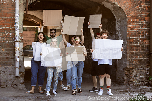 Image of Diverse group of people protesting with blank signs. Protest against human rights, abuse of freedom, social issues