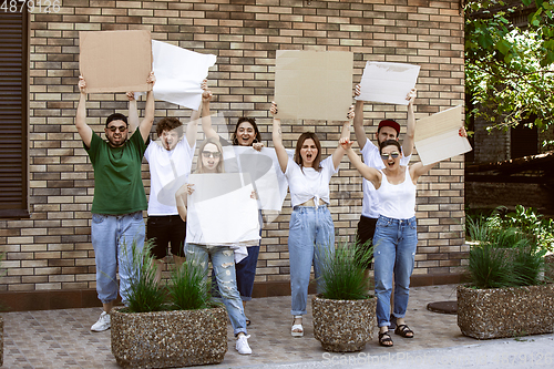 Image of Diverse group of people protesting with blank signs. Protest against human rights, abuse of freedom, social issues