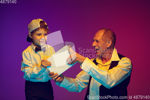 Image of Senior man having fun and spending time together with boy, grandson. Joyful elderly lifestyle concept