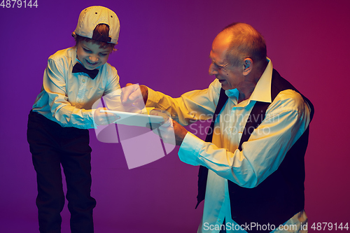 Image of Senior man having fun and spending time together with boy, grandson. Joyful elderly lifestyle concept