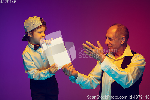 Image of Senior man having fun and spending time together with boy, grandson. Joyful elderly lifestyle concept