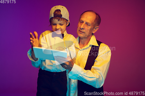 Image of Senior man having fun and spending time together with boy, grandson. Joyful elderly lifestyle concept