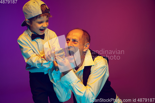 Image of Senior man having fun and spending time together with boy, grandson. Joyful elderly lifestyle concept