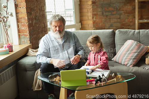 Image of Grandfather and child playing together at home. Happiness, family, relathionship, education concept.