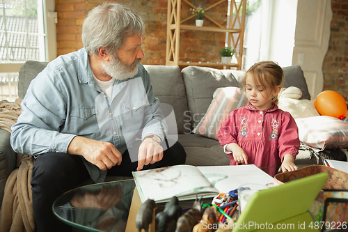 Image of Grandfather and child playing together at home. Happiness, family, relathionship, education concept.