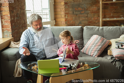 Image of Grandfather and child playing together at home. Happiness, family, relathionship, education concept.