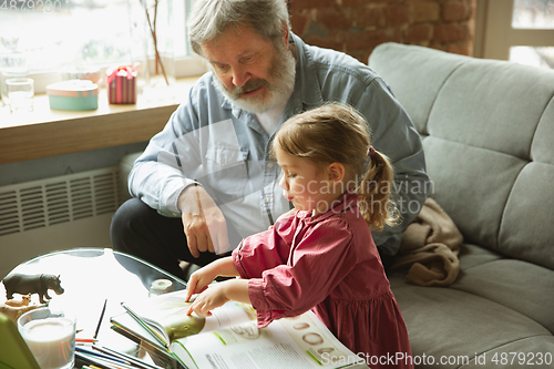 Image of Grandfather and child playing together at home. Happiness, family, relathionship, education concept.