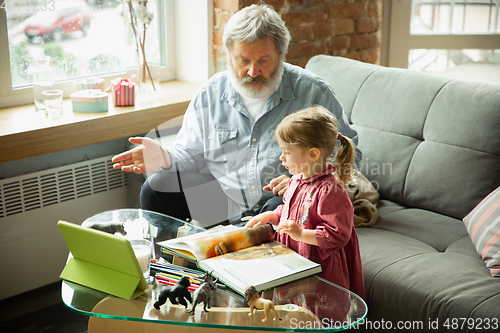 Image of Grandfather and child playing together at home. Happiness, family, relathionship, education concept.