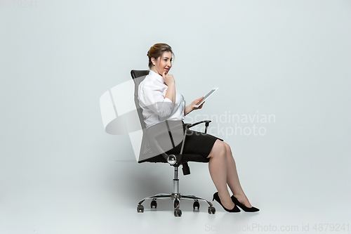 Image of Young caucasian woman in office attire on gray background. Bodypositive female character. plus size businesswoman