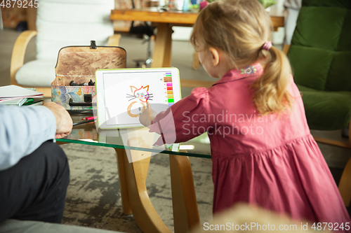 Image of Grandfather and child playing together at home. Happiness, family, relathionship, education concept.