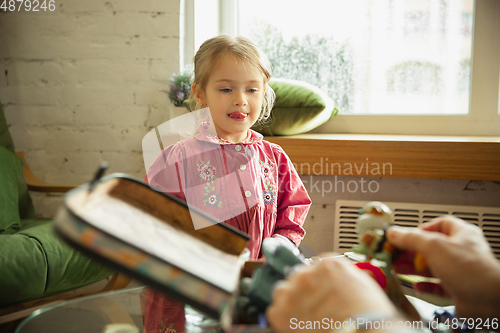 Image of Grandfather and child playing together at home. Happiness, family, relathionship, education concept.