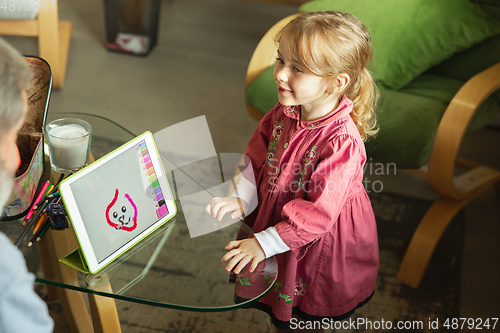 Image of Grandfather and child playing together at home. Happiness, family, relathionship, education concept.