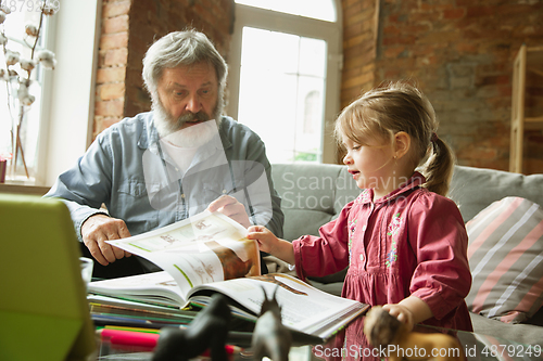 Image of Grandfather and child playing together at home. Happiness, family, relathionship, education concept.